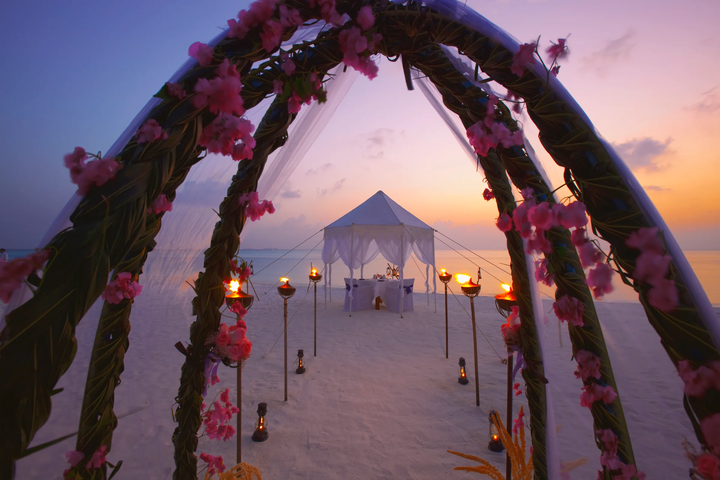 Beach wedding setup at sunset at Anantara Veli Maldives Resort